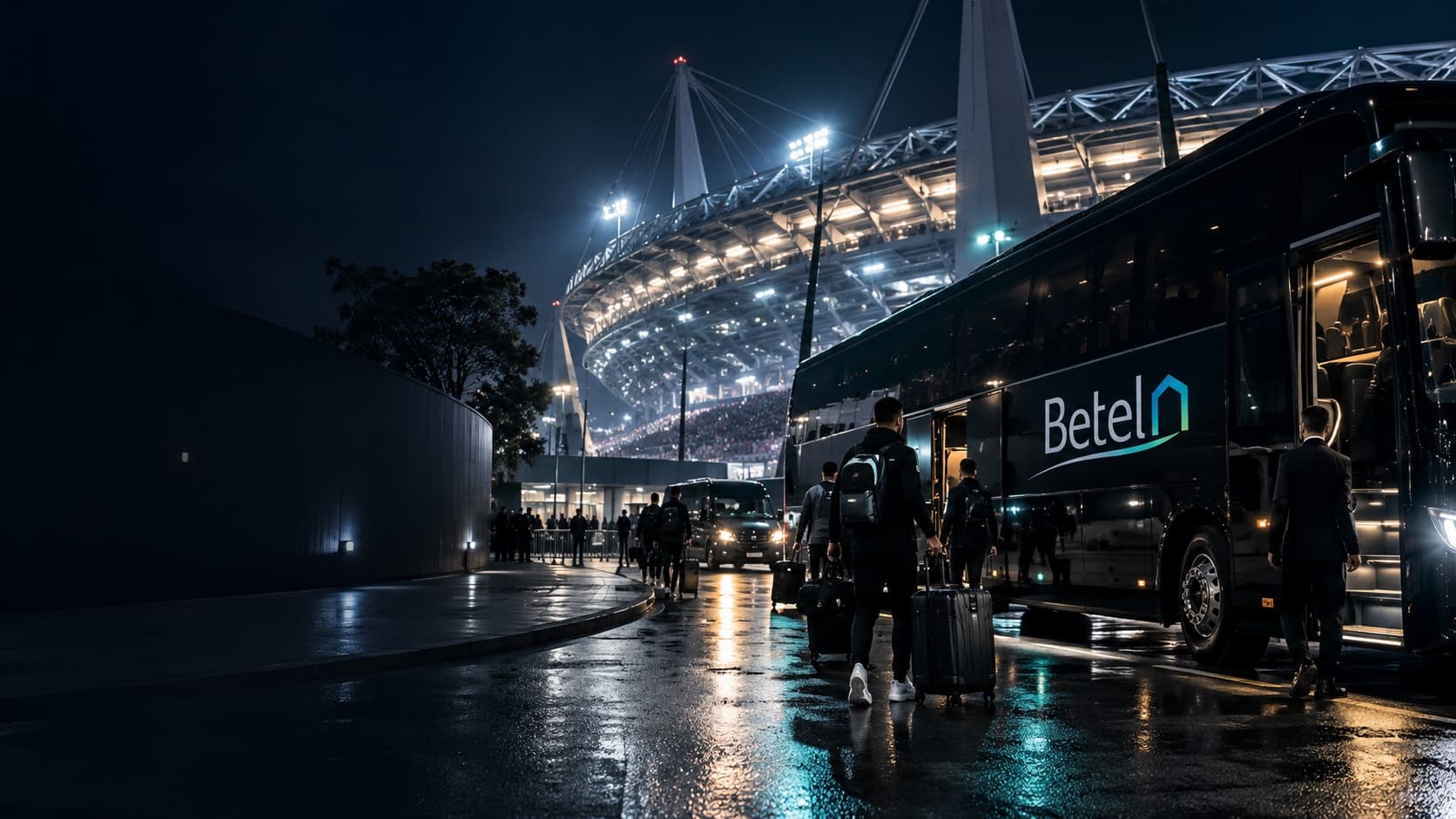 Squadra con i trolley sale sul bus Betel davanti allo stadio illuminato di notte